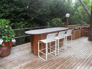 Outdoor bar table on pool deck
